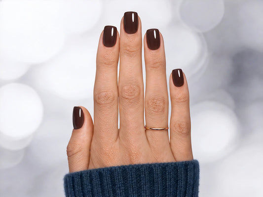 A top-down professional shot of dark espresso glossy short square press-on nails, showcasing the deep chocolate brown color and uniform shape.