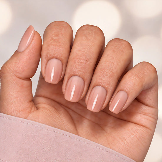 Relaxed hand pose showing short square nude pink ombre press-on nails, ideal for a natural yet polished look.