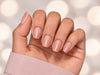 Relaxed hand pose showing short square nude pink ombre press-on nails, ideal for a natural yet polished look.