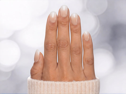 A top-down photo of nude white ombre extra short round press-on nails, showing the elegant gradient perfect for weddings or everyday wear.