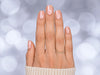 A top-down professional view of short square pink pearlescent chrome press-on nails, highlighting the high-shine metallic finish.