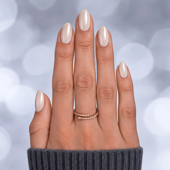 Top-down view of white pearlescent chrome extra short almond press-on nails, featuring a glazed white finish with metallic highlights.