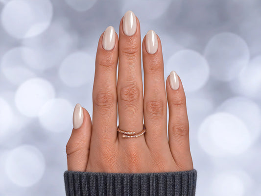 Top-down view of white pearlescent chrome extra short almond press-on nails, featuring a glazed white finish with metallic highlights.