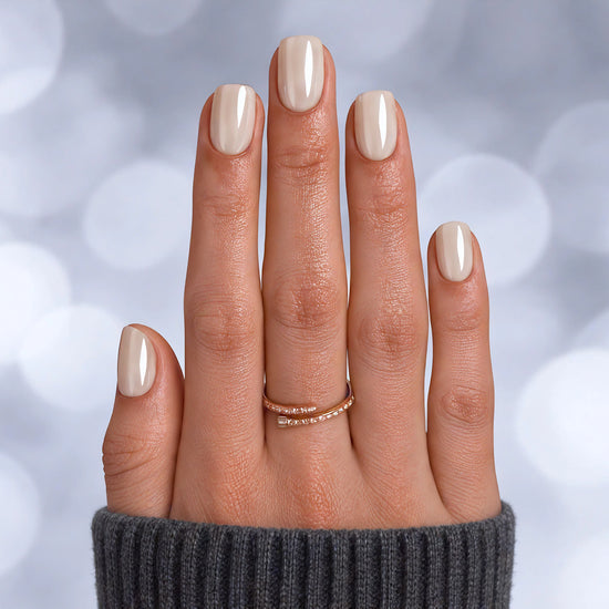 Professional top-down shot of short square white pearlescent chrome press-on nails with a futuristic, high-gloss pearl finish.