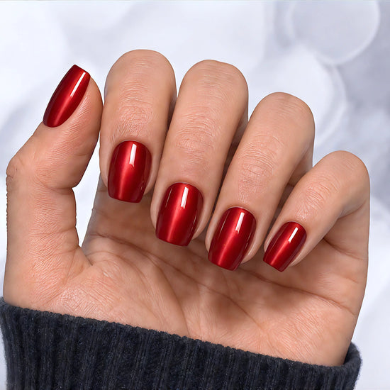 Relaxed hand pose showcasing short square ruby red velvet chrome press-on nails with a luxurious magnetic velvet effect.
