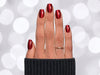 Top-down view of short square shaped ruby red velvet chrome press-on nails, capturing the multidimensional deep red metallic finish.
